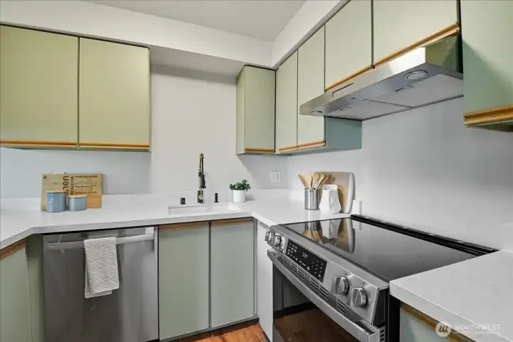 Brand-new kitchen appliances and fixtures give the space a fresh, modern look, enhanced by subtle designer touches.