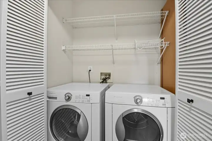 Utility closet with full size washer dryer.