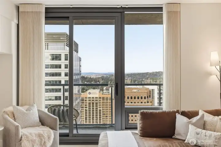 Light-filled living room with floor-to-ceiling windows.