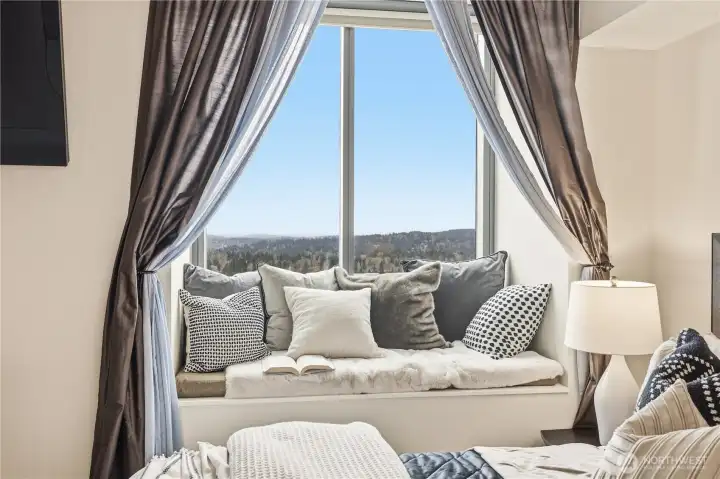 Primary bedroom retreat with framed city and lake views, perfect for relaxing mornings and quiet evenings.