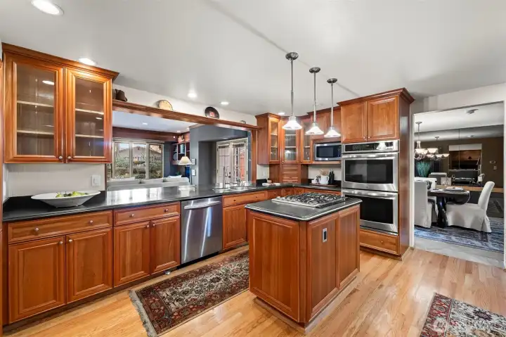 Updated kitchen with cherry cabinets, center island, stainless appliances and more