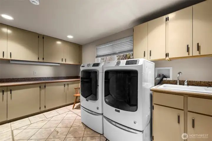 Laundry room with cabinets and sink