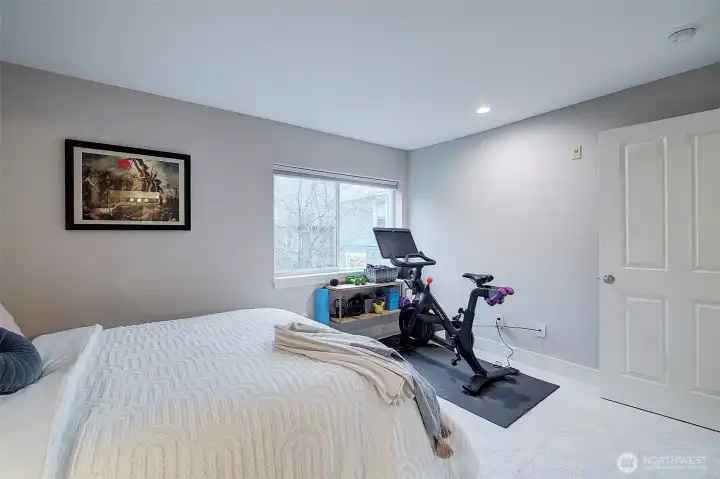 Bedroom is spacious and looks out into trees and a garden. Two closets.