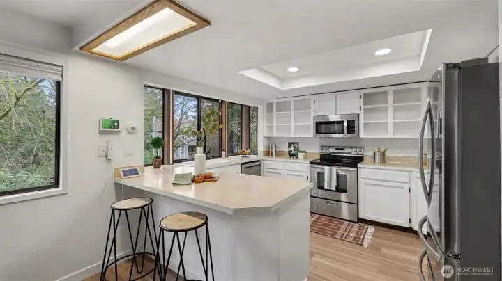 A bright and functional kitchen featuring a spacious peninsula with seating—perfect for casual dining or morning coffee.