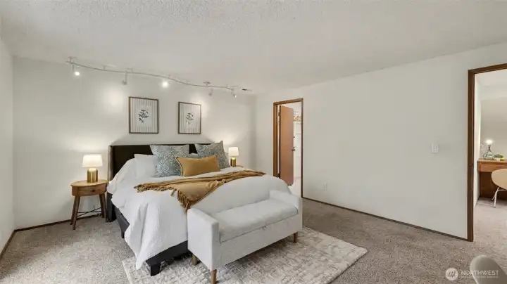 Designed for comfort and flexibility, this primary suite offers ample space for both rest and relaxation.