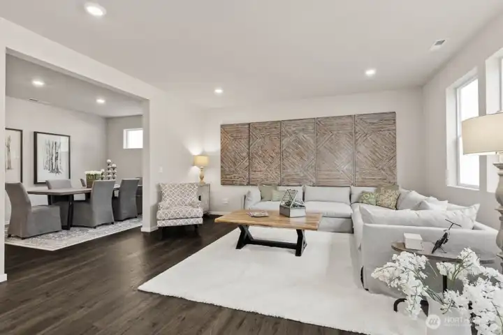 Large open great room. **Photo is representational. Photos virtually staged Actual home is under construction. Colors, materials, and features may vary. See site agent for details.**