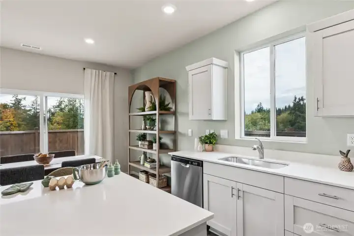 Breakfast nook with space for small office space or hutch. **Photo is representational. Photos virtually staged Actual home is under construction. Colors, materials, and features may vary. See site agent for details.**