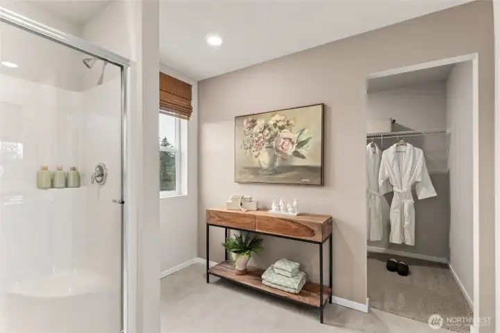 Primary bathroom with step in shower and large space for makeup vanity. Double vanity with quartz countertops included. **Photo is representational. Photos virtually staged Actual home is under construction. Colors, materials, and features may vary. See site agent for details.**