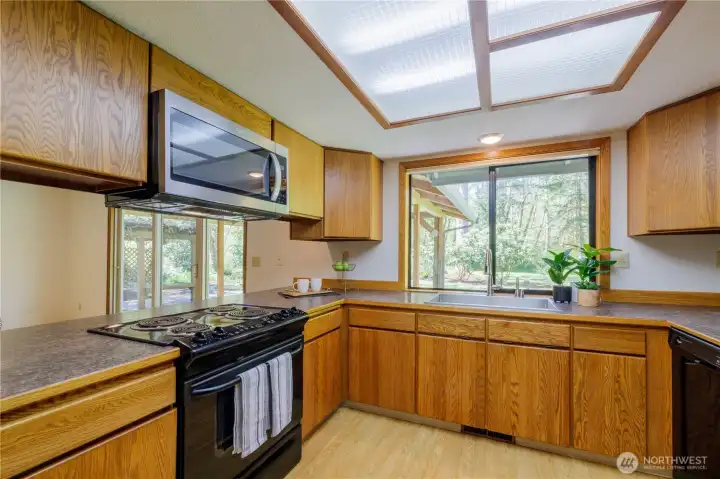 Outlook to the back yard and room for a breakfast bar at the counter too.