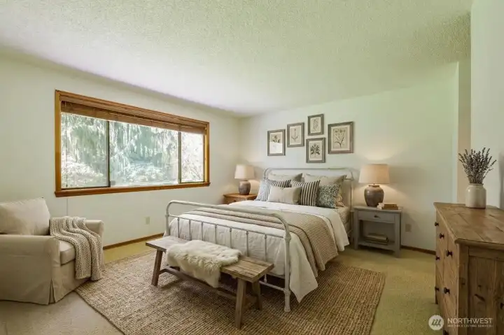 Primary suite occupies a corner of the home with views to the backyard.