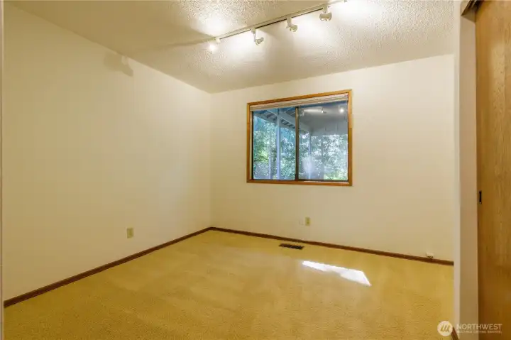 Located near living spaces, this room functions well as an office or den too, with built-in nook for a desk.