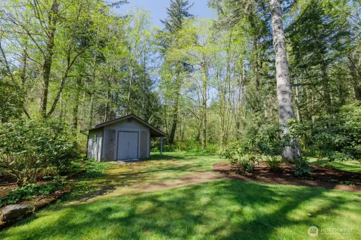 Storage shed for your garden needs - property also has a covered woodshed!