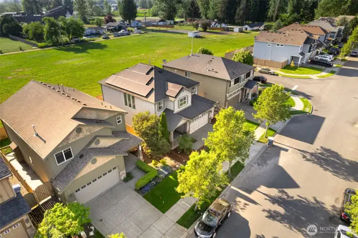 House in the middle with open field behind.