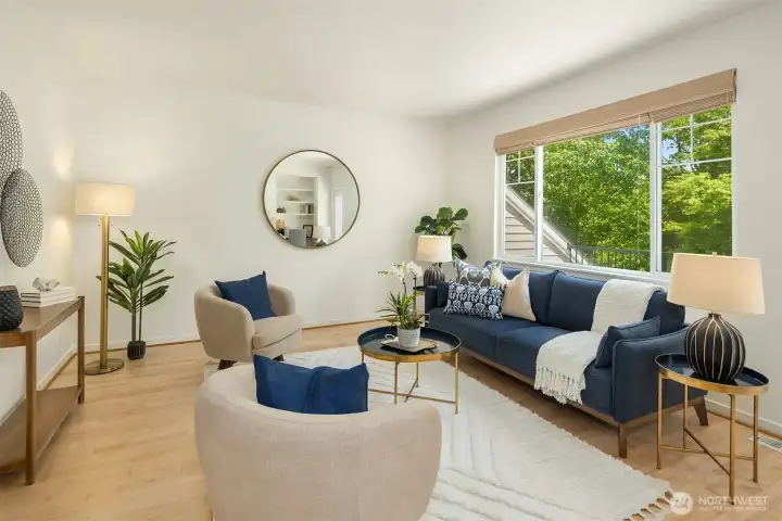 A fantastic space with high ceilings, newly-refinished hardwood flooring, and a view of green space.
