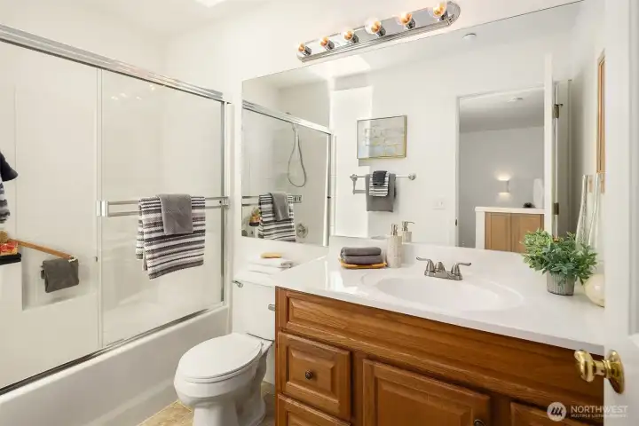 The full hall bath has a large skylight, flooding the room with natural light.