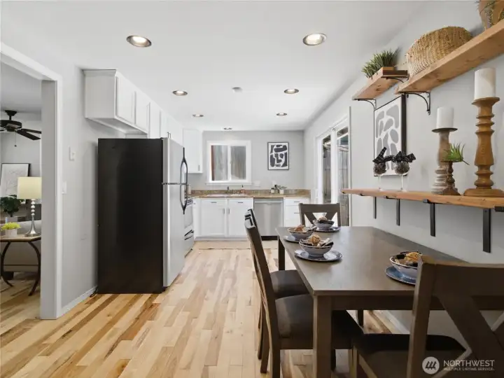 Bright kitchen with stainless appliances, with slider leading to courtyard patio.