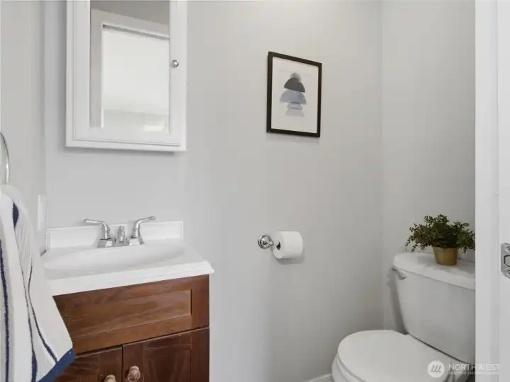Functional half bathroom with pocket door.