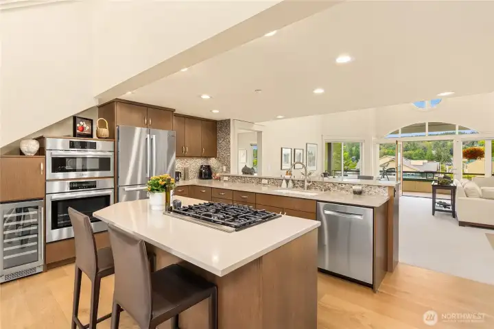 Premium stainless Bosch appliances including built-in oven, microwave, gas cooktop, refrigerator, dishwasher,  and warming drawer in addition to a Zephyr 27-bottle wine cooler. And the best feature? That incredible view.