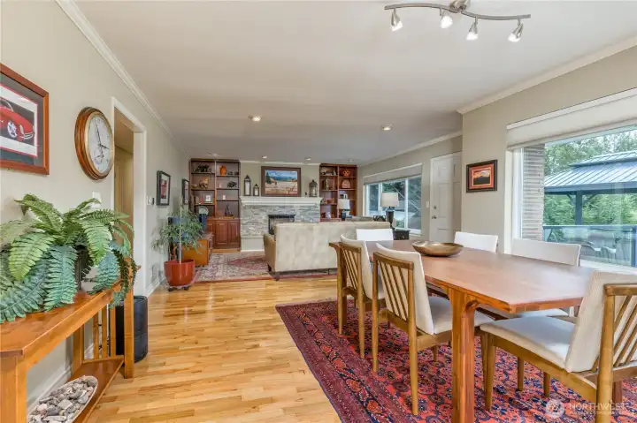 Bright, open living and dining areas featuring stunning, rich hardwood flooring.