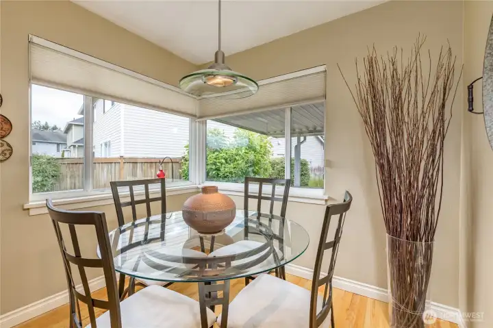 Sun-drenched breakfast nook featuring corner windows; the perfect spot for your morning coffee.