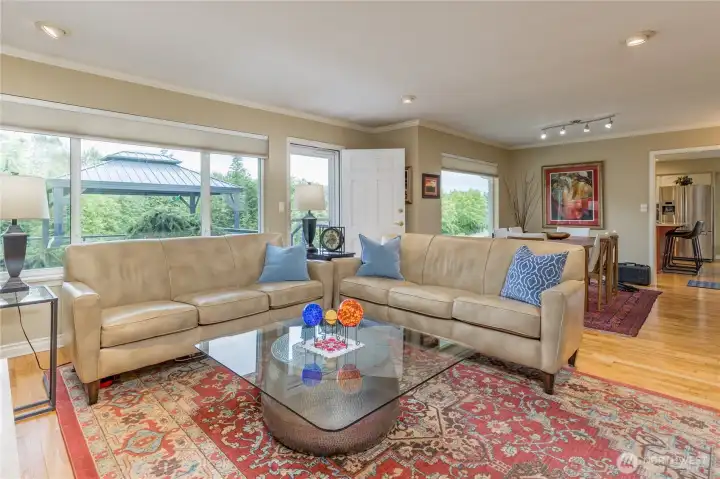 Large windows with custom shades allow you to take in the serene back yard view.