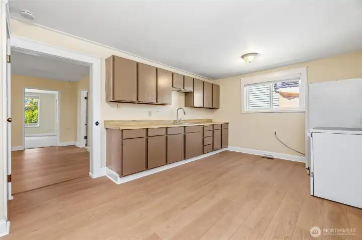 From the living room, you can walk into a spacious kitchen with eating space and substantial storage space. From the living room, you can walk into a spacious kitchen with eating space and substantial storage space.