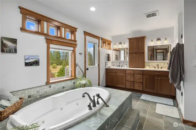 Primary Suite bathroom features a Kohler jetted tub, a separate shower with dual heads, double sinks, large walk-in closet & a balcony too! Did I mention BOTH upper & lower floors have radiant heat? It feels pretty toasty on these slate floors!