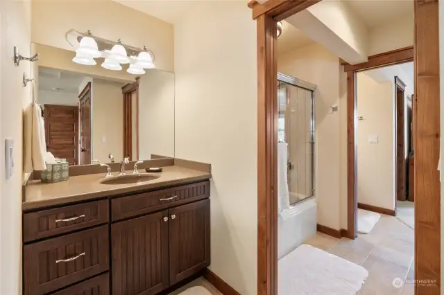 The 2 guest rooms have their own private sink area, & share a "jack & jill" full bathroom.