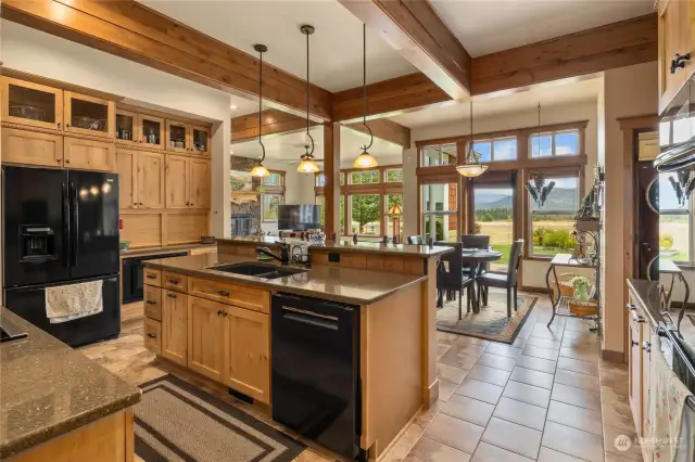 Kitchen is a dream with quartz counters, TONS of custom maple wood cabinetry. Double ovens, new dishwasher, BIG walk-in pantry, &  an eating bar!