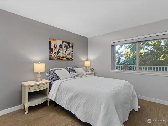 Large bedroom is flooded with natural light.