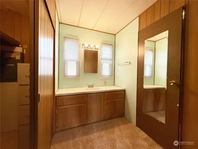 Another deep closet on the left as you enter the Primary Bathroom with an extra wide vanity area and cabinets. (Water closet on the right.)