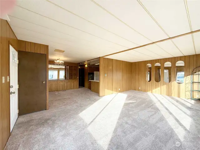 Entry door on the left. The Living Room and Dining Room flow into the Kitchen area.