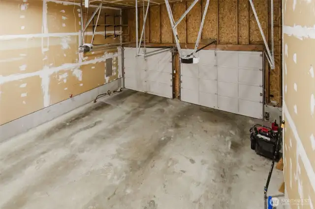 View into garage from inside of home access stairs