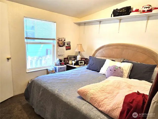 Second bedroom features overhead shelving.
