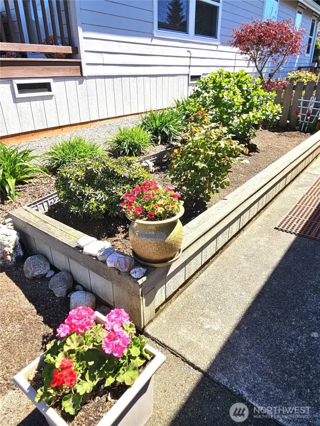 Attractive garden beds leading to front entry.