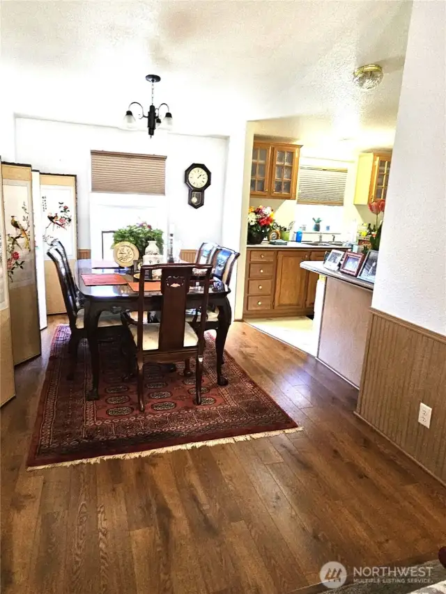 Laminate plank flooring in entry and dining area.