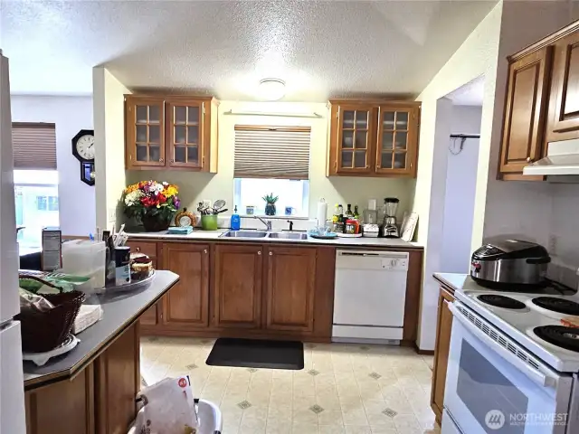 The open kitchen features stylish well-crafted cabinets that add both charm and functionally to the space.
