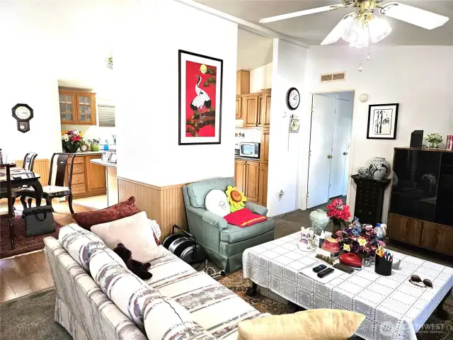Attractive living room boasts a circular floor plan connecting effortlessly to the kitchen, dining room and guest bedroom.