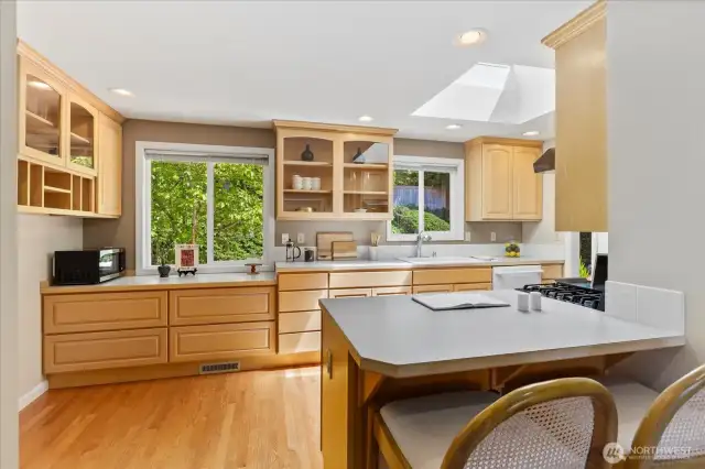 Additional storage and cabinetry added for improved efficiency. Skylight and counter seating. Access from kitchen to 2-car garage.