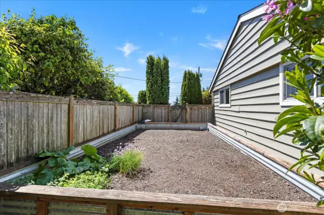 Level garden bed on south side of the home; keep as is or could be converted to additional yard space.