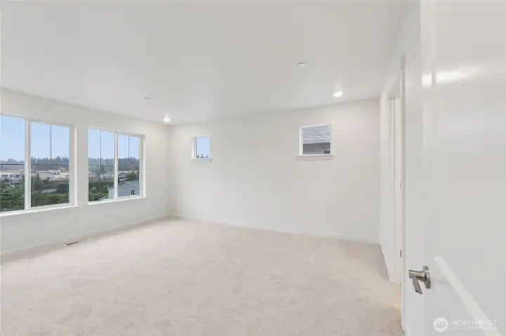 Primary bedroom with unobstructed views looking West. Primary bedroom with unobstructed views looking West.