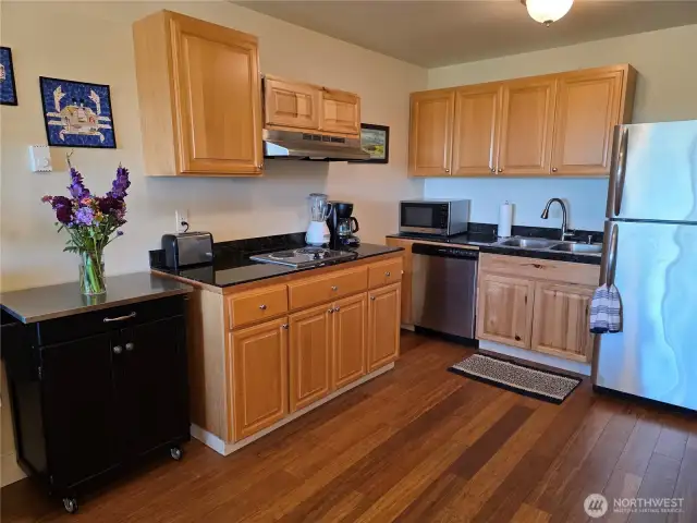 The kitchen has full size refrigerator and dishwasher, and a mobile cart for flexibility