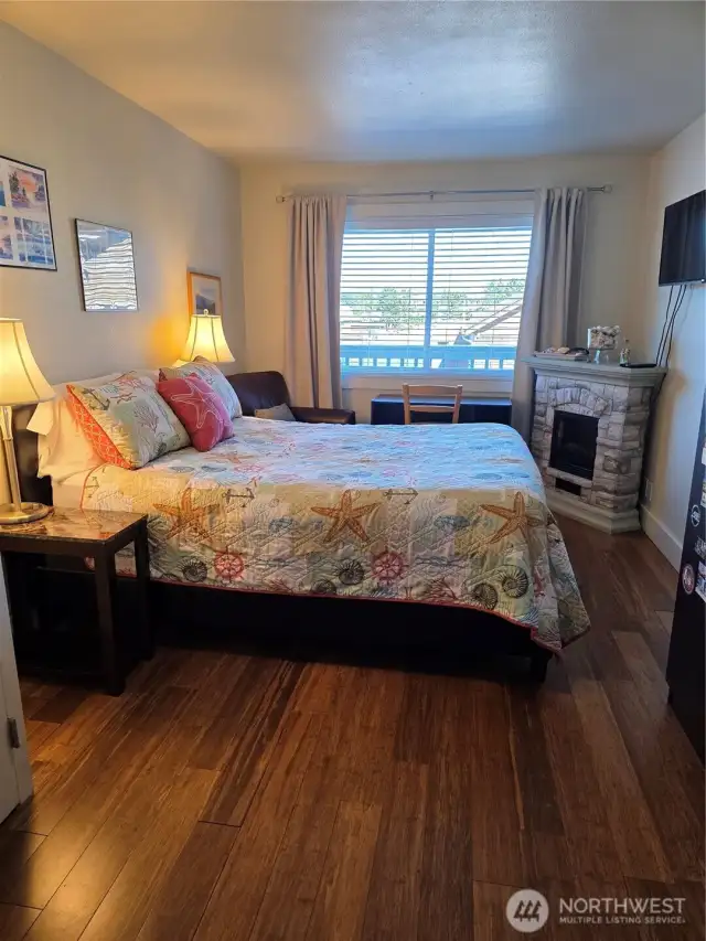 Notice the beatiful real wood floors throughout.  The primary suite has a private full bath and comes with television and electric fireplace.  There is a locking armoire full of high quality linens for the bedroom, bath, and kitchen.