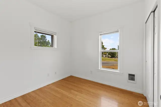 Primary bedroom with beautiful bamboo floors. This bedroom has views of the Cascade Mountains and Snohomish River.