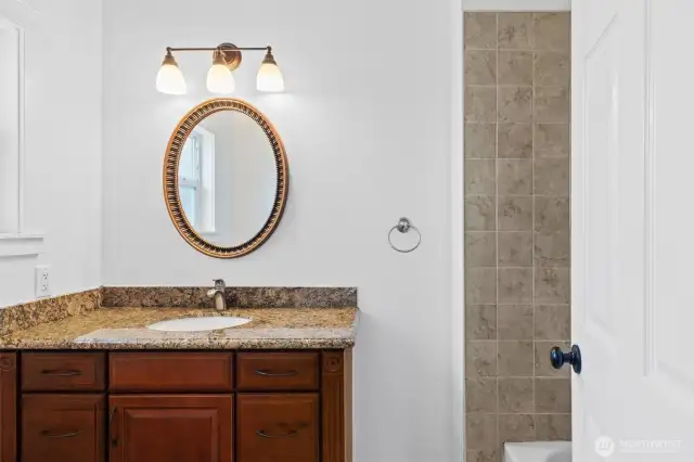 Nice full bath with tiled floors and tile surround in the tub/shower