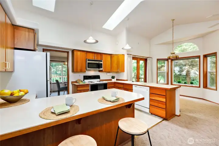 One could dine at the counter or there is an eating space to the right.