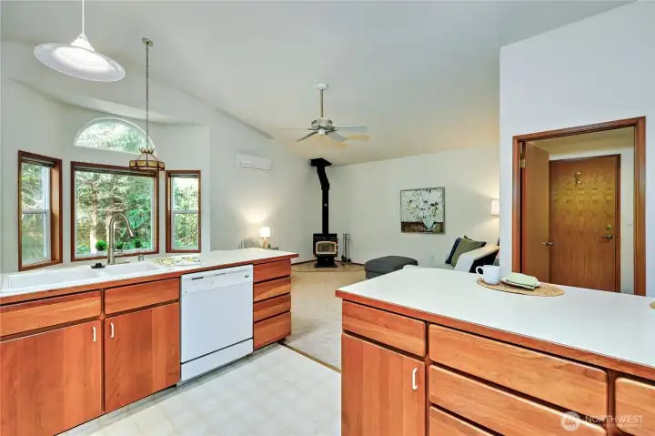 Off of the kitchen is a family room with a wood fireplace. Door on the right leads to the laundry room and garage.