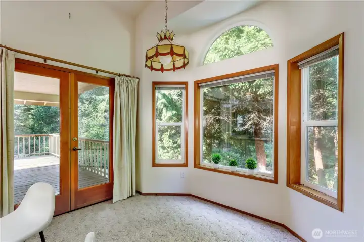 Kitchen area for dining with double doors leading to the deck.