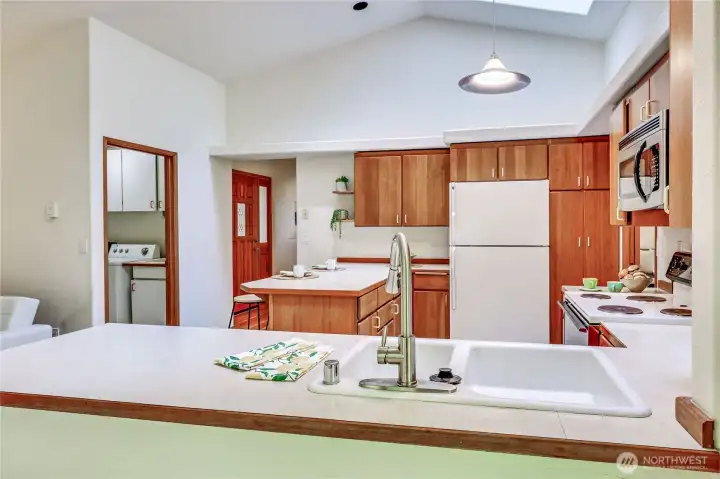 Here is a view from the kitchen nook eating area.  Notice the solid wood cabinets, skylights and an abundance of counter space.