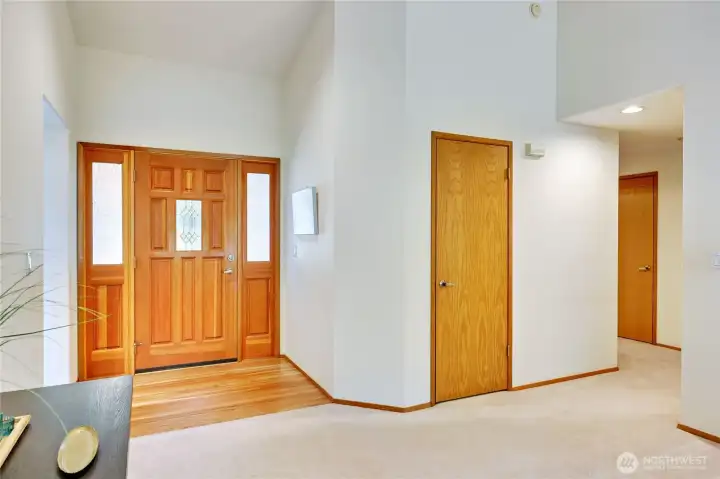 Back at the front door, let's go to the other side of the house where the bedrooms are located.  Coat closet is ahead and linen closet to the right.